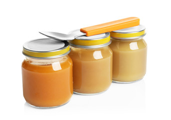 Jars with different baby food on white background