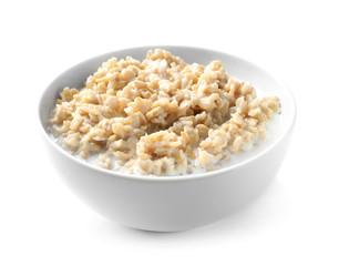 Bowl with yummy oatmeal against white background