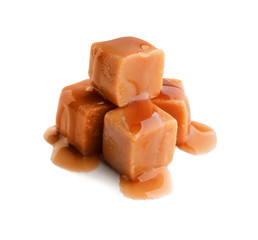 Sweet candies with caramel topping on white background