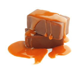 Sweet chocolate candies with caramel topping on white background