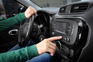 Fototapeta na wymiar Man tuning radio in car