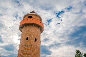 Circle Tower made of orange brick and blue sky background  .