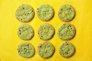 Mint chocolate chip cookies on yellow background