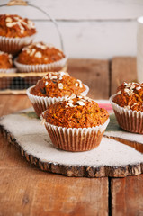 Healthy carrot cake muffins on a wooden board.