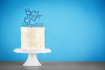 Stand with delicious cake for baby shower party on color background