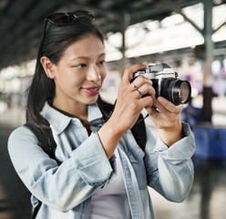 An Asian traveler using a camera