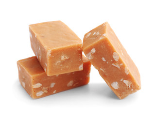 Delicious caramel candies on white background