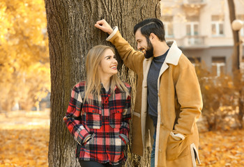 Young couple in park on autumn day