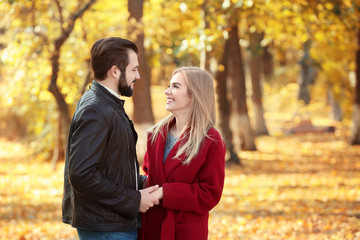 Fototapeta premium Young couple in park on autumn day
