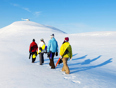 Group of snowboarders enjoying a beautiful winter morning.