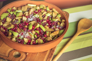 Homemade Apple pie on a wooden board with green apples and red currants. Then baking a cake in oven. Food concept. An intimate, homely atmosphere.