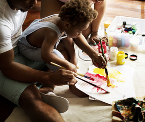 Black kid enjoying color painting