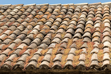Old fashioned style roof tiles on rural building in Provence France