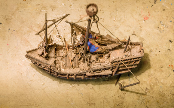Old wooden boat model on the table.