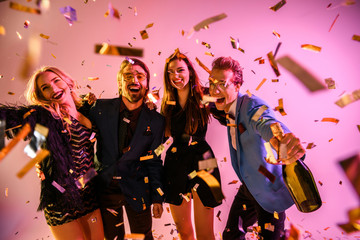 excited friends on party with confetti