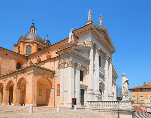 Naklejka premium Urbino, Italy - August 9, 2017: The Cathedral. Piazza Duca Federico. Sculpture and statue in architecture.