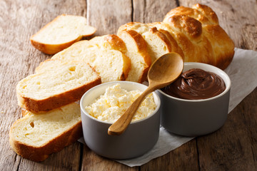 sliced fresh brioche bread and cream cheese, chocolate cream close-up. horizontal