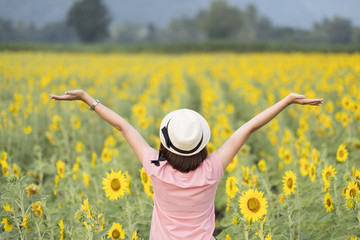 Happy girl in sunflower field