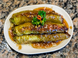 Shanghai Style Foods, Green Chillies with Marinated Stuffed Minced Meat closeup with selective focus on background.