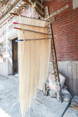 Obraz premium Changhua Lukang Fuxing handmade noodles - October 22 ,2017:The traditional way to dry fine flour in Taiwan, hanging chinese noodles.