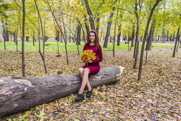 Autumn woman on the background of leaves.