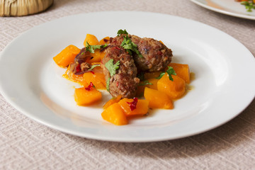 cutlets with a garnish of pumpkin