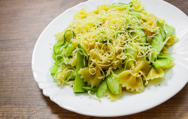 pasta farfalle salad with cucumber and cheese on plate