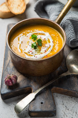 homemade pumpkin soup with cream and pumpkin seeds