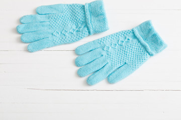 blue gloves on white wooden background