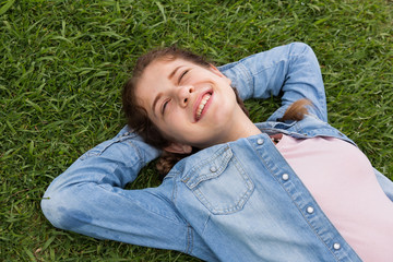 portrait of  young female while lying in spring green garden