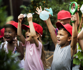Group of kindergarten kids learning gardening outdoors