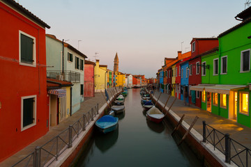 Colorful houses and boats at evening in Burano, Venice Italy.