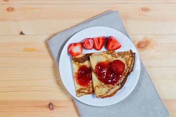 Crepes with fresh strawberries and jam