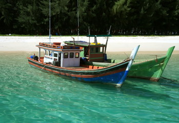 Fototapeta na wymiar Fishermen boats near a beach in Thailand