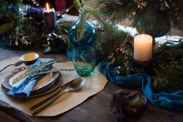 Vintage silverware with a twig of rosemary and empty tag on rustic wooden background