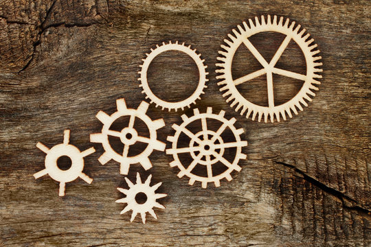Wooden gears on wooden background © rvlsoft