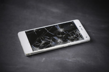 Modern smart phone with broken screen.