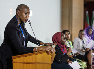 A Middle African Descent Woman Speaking into a Microphone