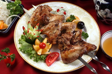 Kebab of chicken wings.Onion,pomegranate grains,coriander seeds,cumin,red pepper-sweet.Served with salad and tea.Uzbek cuisine.