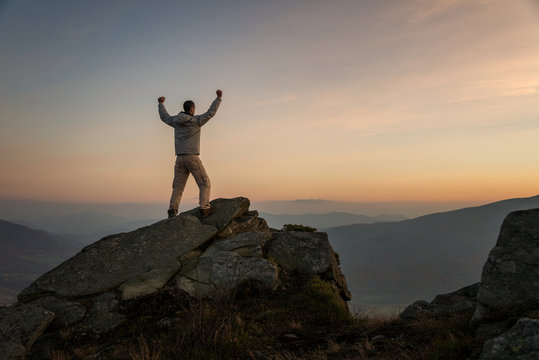 Happy male hiker on mountain top