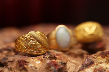 Old golden ring on stone texture