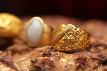 Old golden ring on stone texture