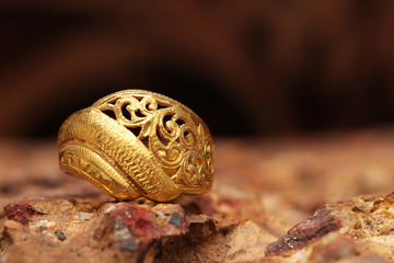 Old golden ring on stone texture