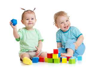 Funny kids playing colorful toys isolated on white