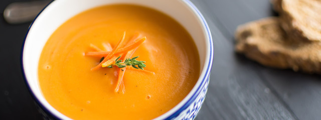 Carrot Soup Served in Bowl with Bread. Homemade Cream Carrot and Potato Pottage.