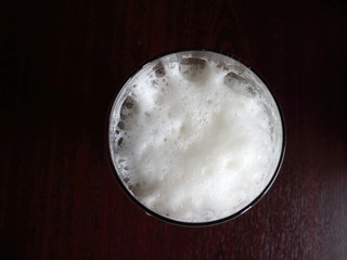 beer foam in a glass top view on a dark background