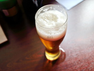 glass of beer, beer foam in a glass blur on a dark background