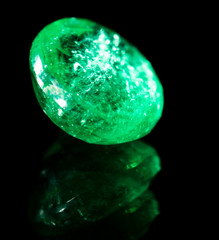 green gem on a black background.