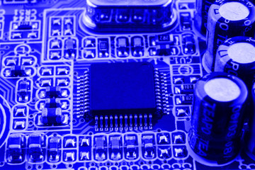 Resistors, capacitors and other electronic components of micro chip inside the computer close up