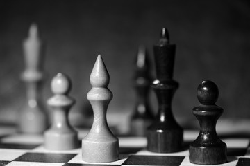 Chess figures on a chessboard. Black and white